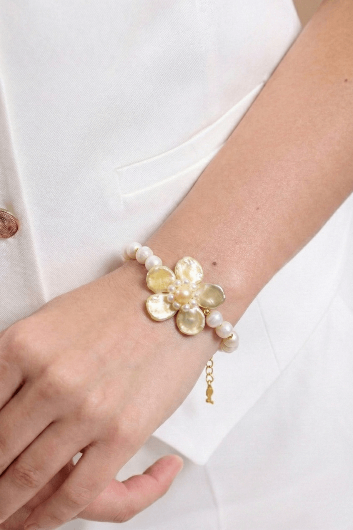 Doğal inci çiçek bileklik, zarif inci detaylarıyla süslenmiş, el bileğinde gösterişli bir aksesuar.