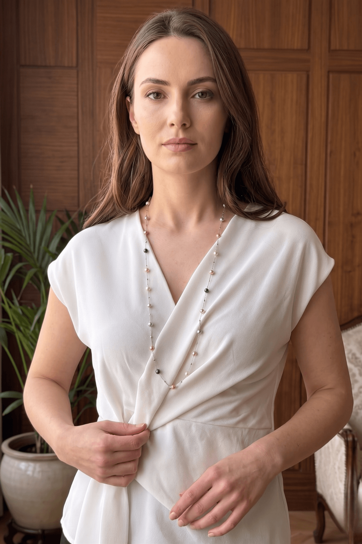 Model wearing Color Nova Dorikalı Uzun Doğal İnci Kolye, şık beyaz bluz ile kombinlenmiş doğal inci kolye.