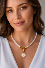 Natural pearl necklace with quarter gold worn by a woman, showcasing elegance and craftsmanship.