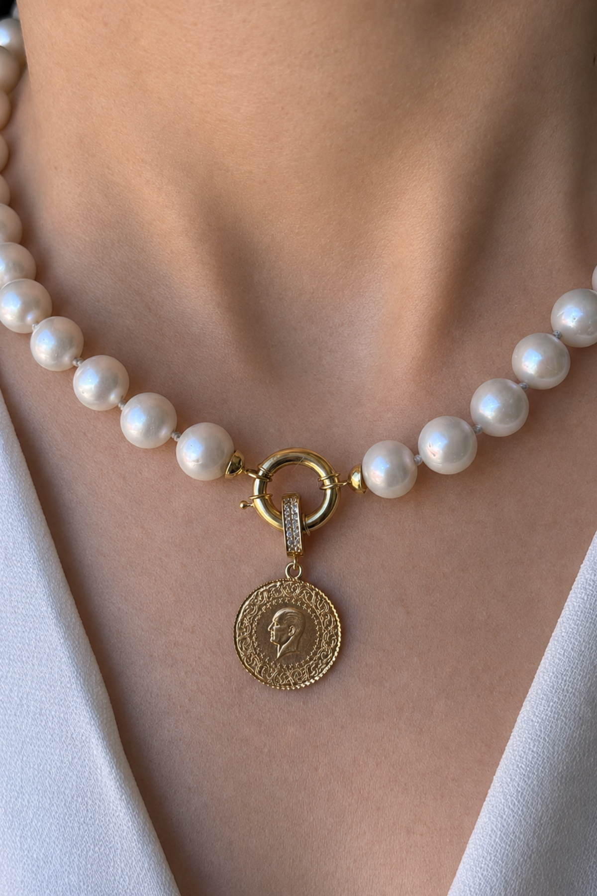 Natural pearl necklace with quarter gold featuring a charm and unique pearls.