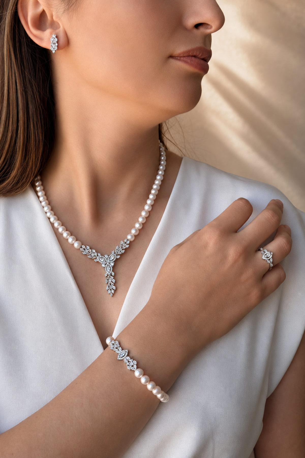 Natural pearl jewelry set worn by a model, featuring a necklace, bracelet, and earrings on a light background.