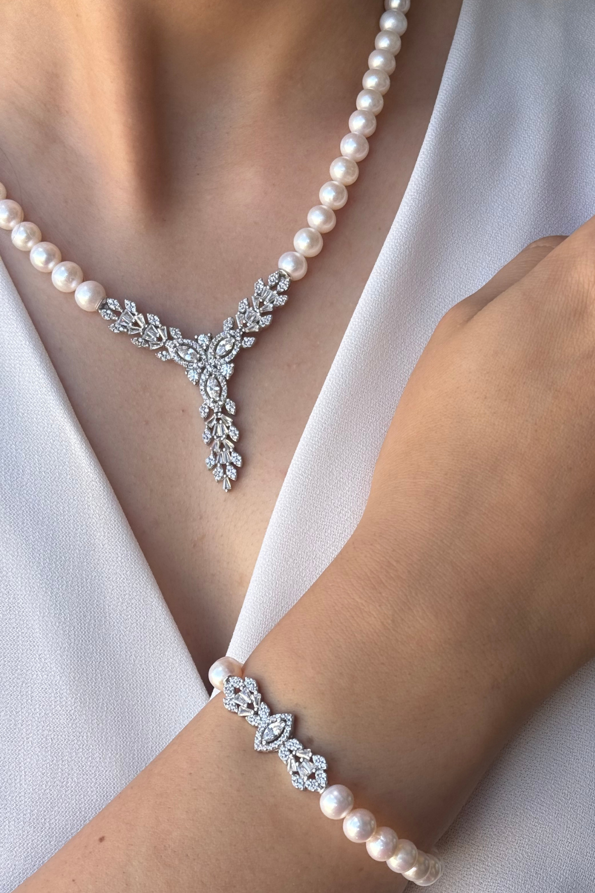 Natural pearl jewelry set featuring a necklace and bracelet with elegant design.
