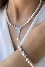 Natural pearl jewelry set featuring a necklace and bracelet, showcasing elegant design with pearls and diamonds.